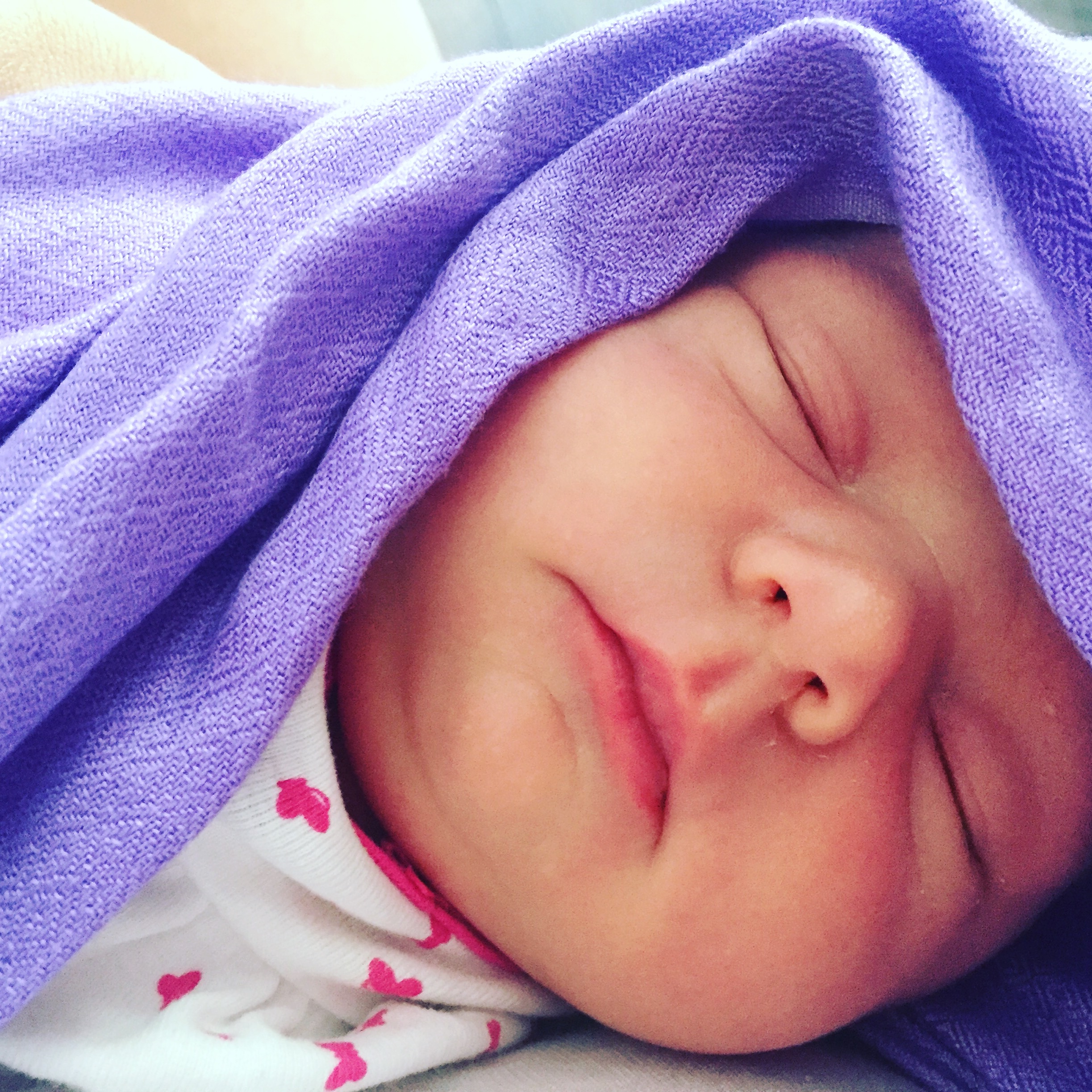 Baby sleeping with purple blanket